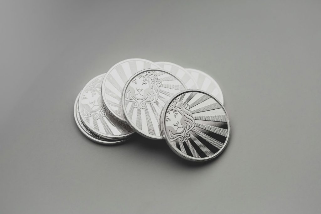 a set of four silver coins sitting on top of a table