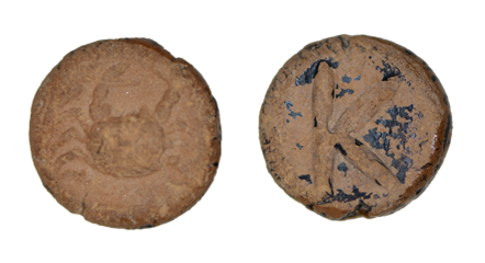 Ancient terracotta token with a worn figurative relief on one side and a partially preserved linear symbol on the other.