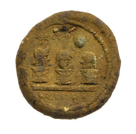Ancient artifact with three figures