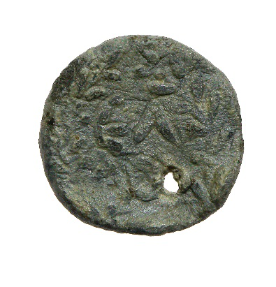 Ancient bronze token with dense relief decoration and a small perforation near the lower edge.